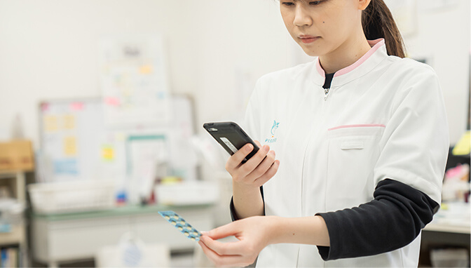 処方する薬をスマホで撮影して処方管理専用アプリに登録している様子