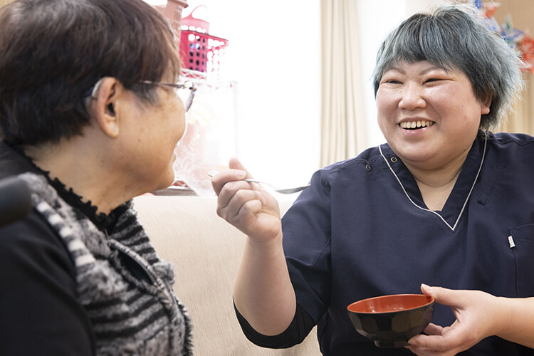 ご利用者様宅で食事の介助をする介護士